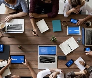 a group of people with laptops